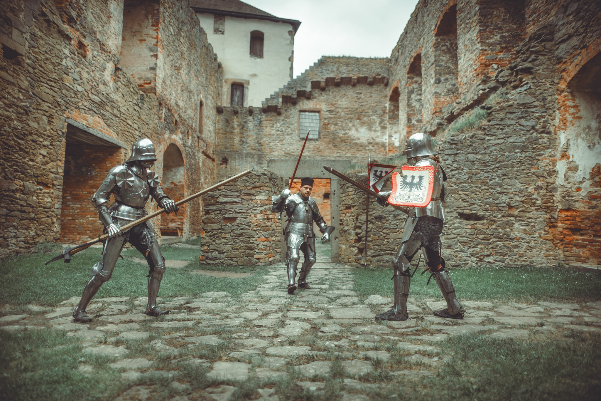 Adeptus group of armored fighters in a castle courtyard